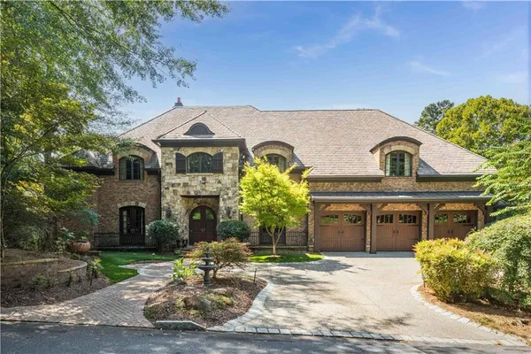 a front view of a house with a garden