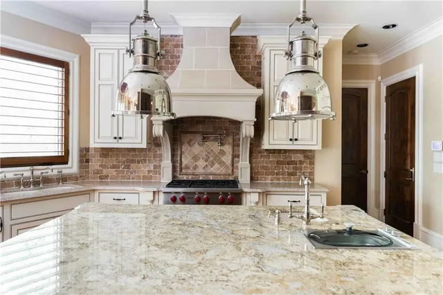 a bathroom with a granite countertop sink a mirror and a bathtub