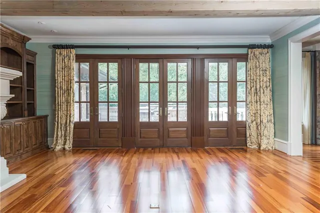 a view of an empty room with a fireplace and a chandelier