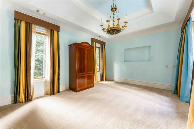 a living room with a fireplace and a floor to ceiling window