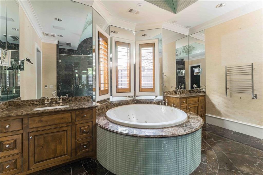 3558 Mill Creek Road Northeast Atlanta, GA 30319 - Photo 37 of 88 a bathroom with a granite countertop sink a mirror and a bathtub