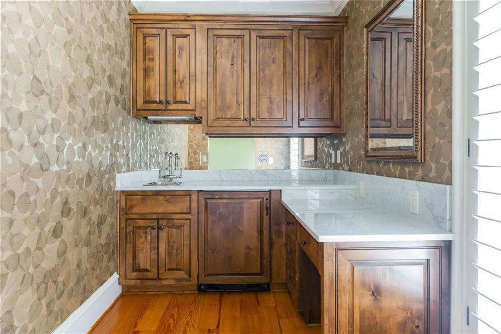 3558 Mill Creek Road Northeast Atlanta, GA 30319 - Photo 50 of 88 a kitchen with granite countertop a sink and dishwasher cabinets with wooden floor