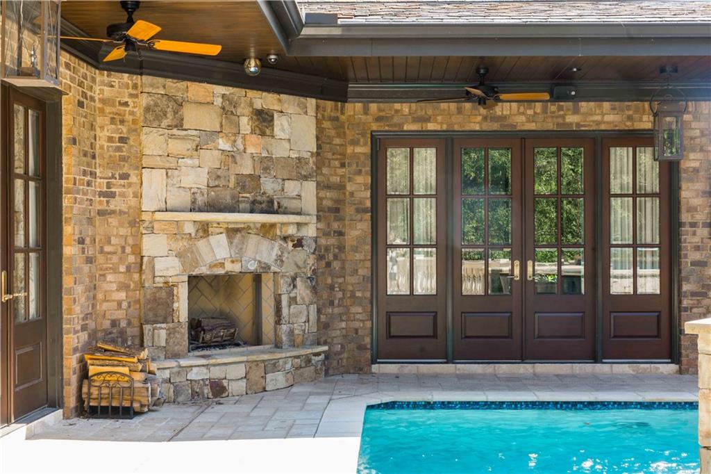 3558 Mill Creek Road Northeast Atlanta, GA 30319 - Photo 60 of 88 a living room with a fireplace and a floor to ceiling window