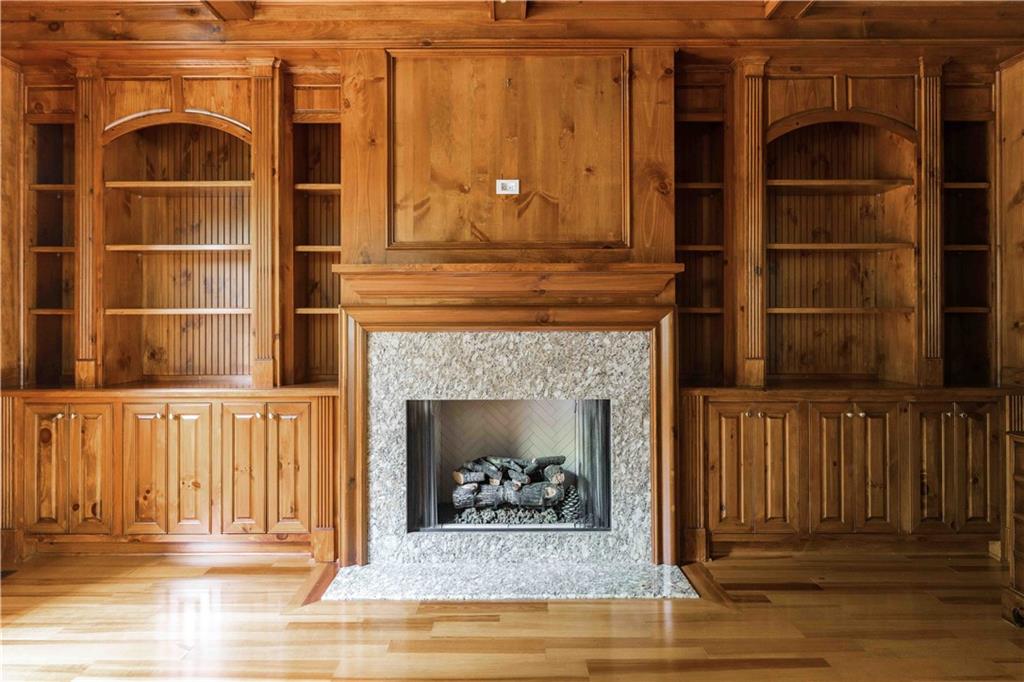 3558 Mill Creek Road Northeast Atlanta, GA 30319 - Photo 10 of 88 a living room with a fireplace and a wooden floor