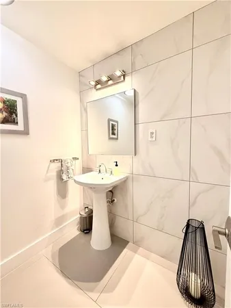 a bathroom with a sink a toilet and mirror