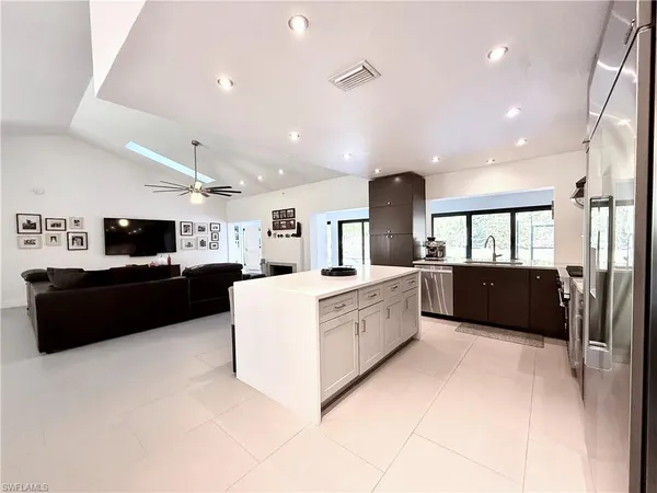 a large white kitchen with a large window