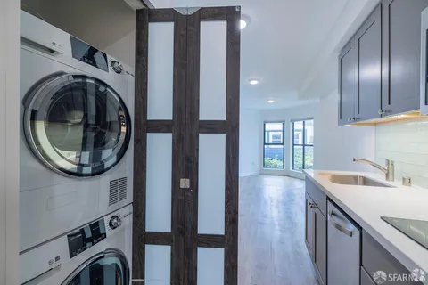 a white bath tub sitting next to a white sink and a mirror