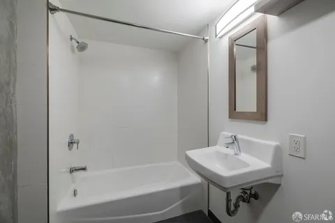 a kitchen with a sink a microwave a refrigerator and cabinets