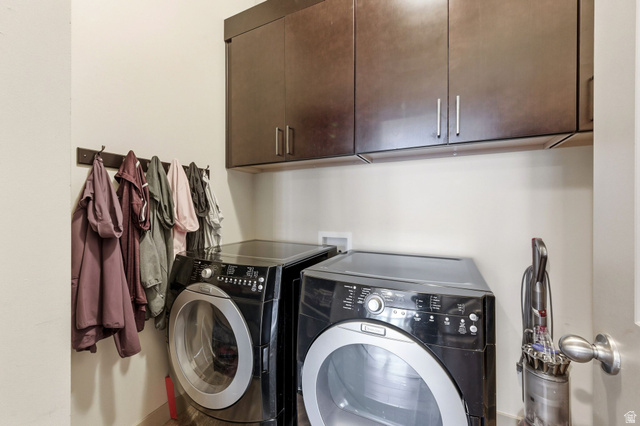 987 East Deer Arch Lane Draper, UT 84020 - Photo 31 of 46 Upstairs laundry area featuring cabinet space, washer, and dryer