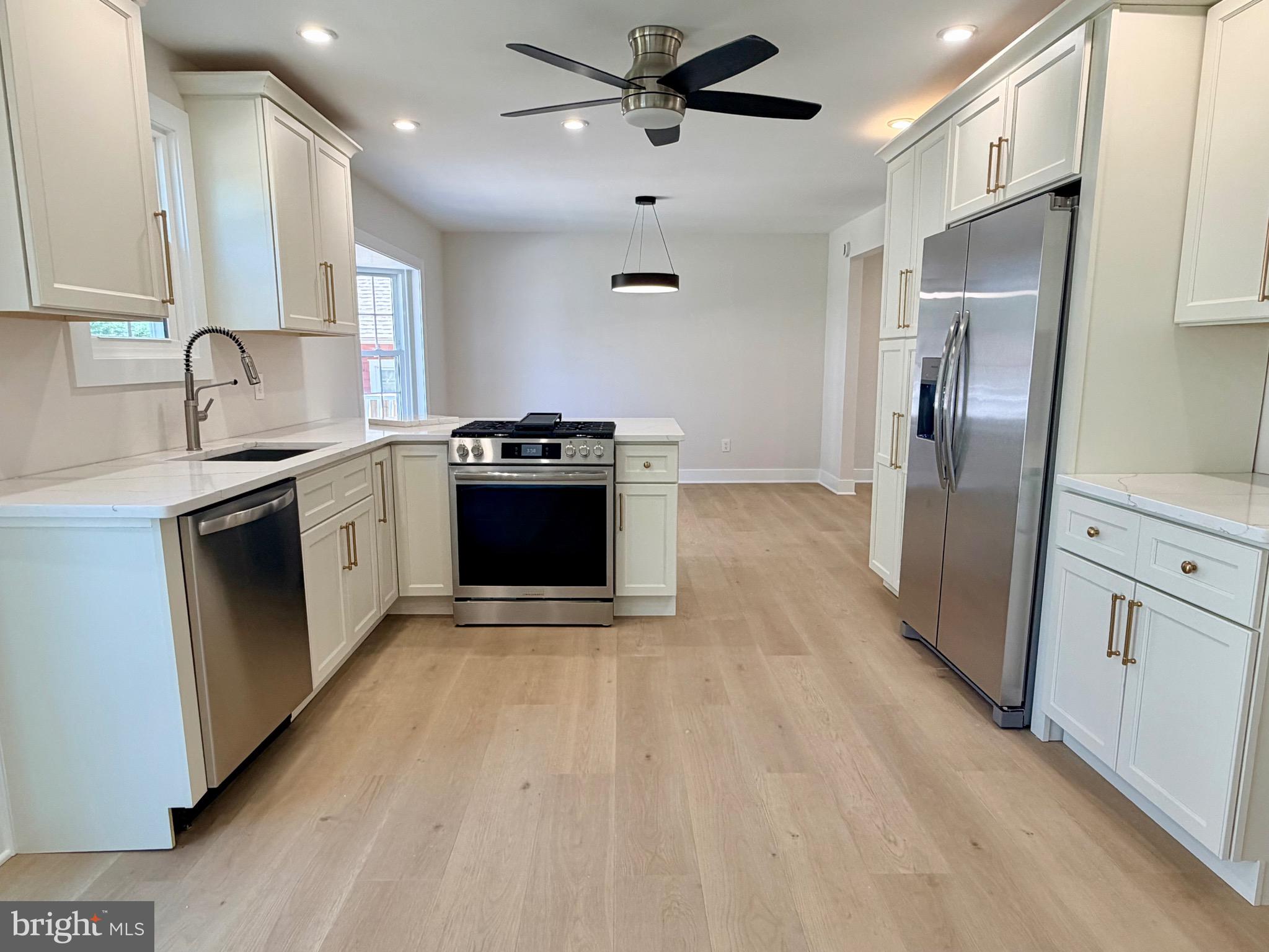 31 Berkley Road Broomall, PA 19008 - Photo 14 of 33 a kitchen with stainless steel appliances granite countertop a sink stove and refrigerator