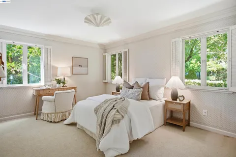 a bedroom with a large bed and a chandelier