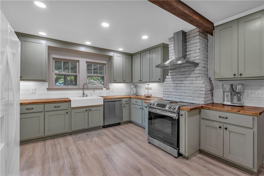 210 McCanless Street Cartersville, GA 30120 - Photo 7 of 27 a kitchen with granite countertop a sink stainless steel appliances and cabinets