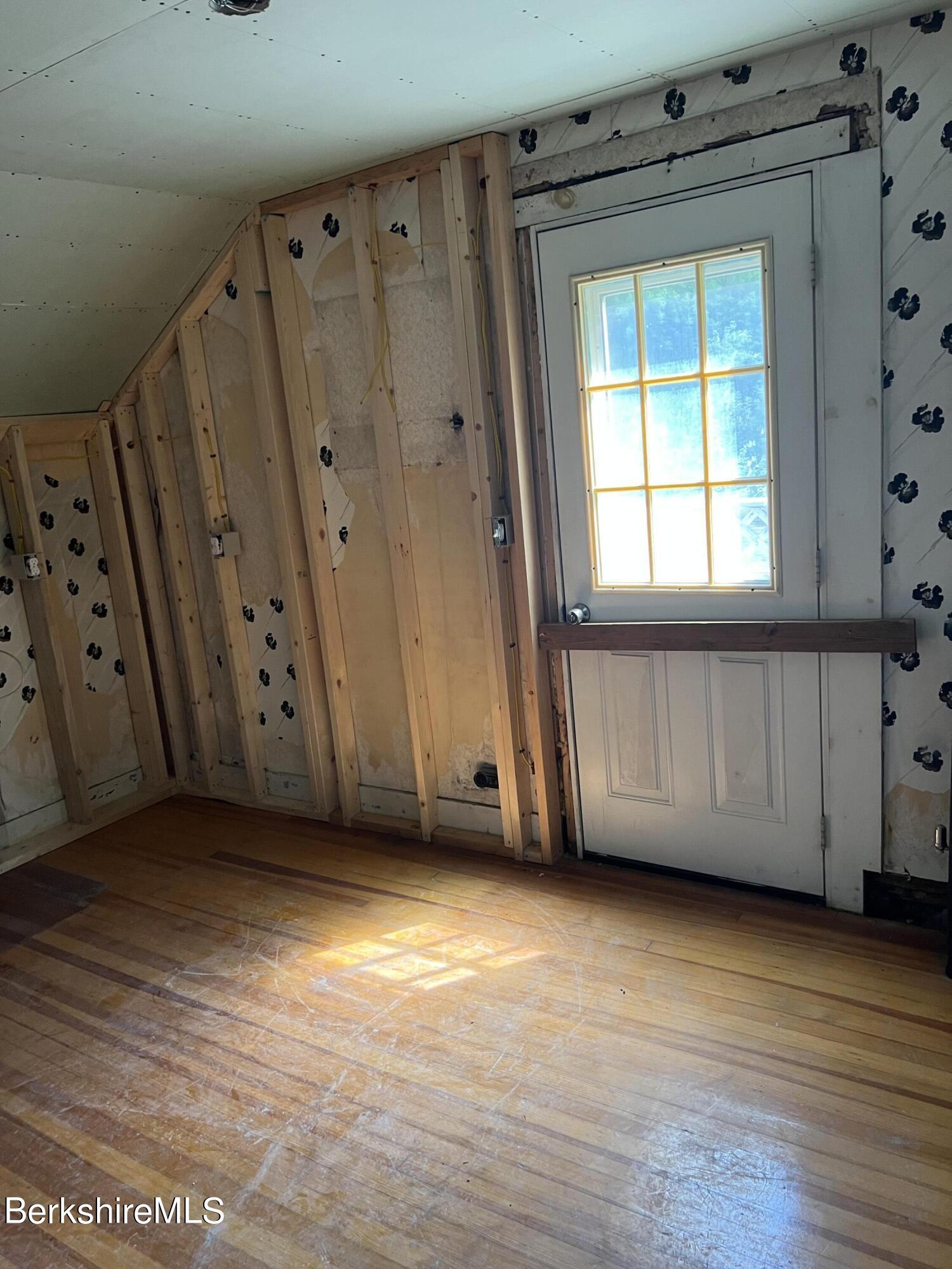 111 Columbia Street Adams, MA 01220 - Photo 20 of 21 a view of an empty room with wooden floor and a window