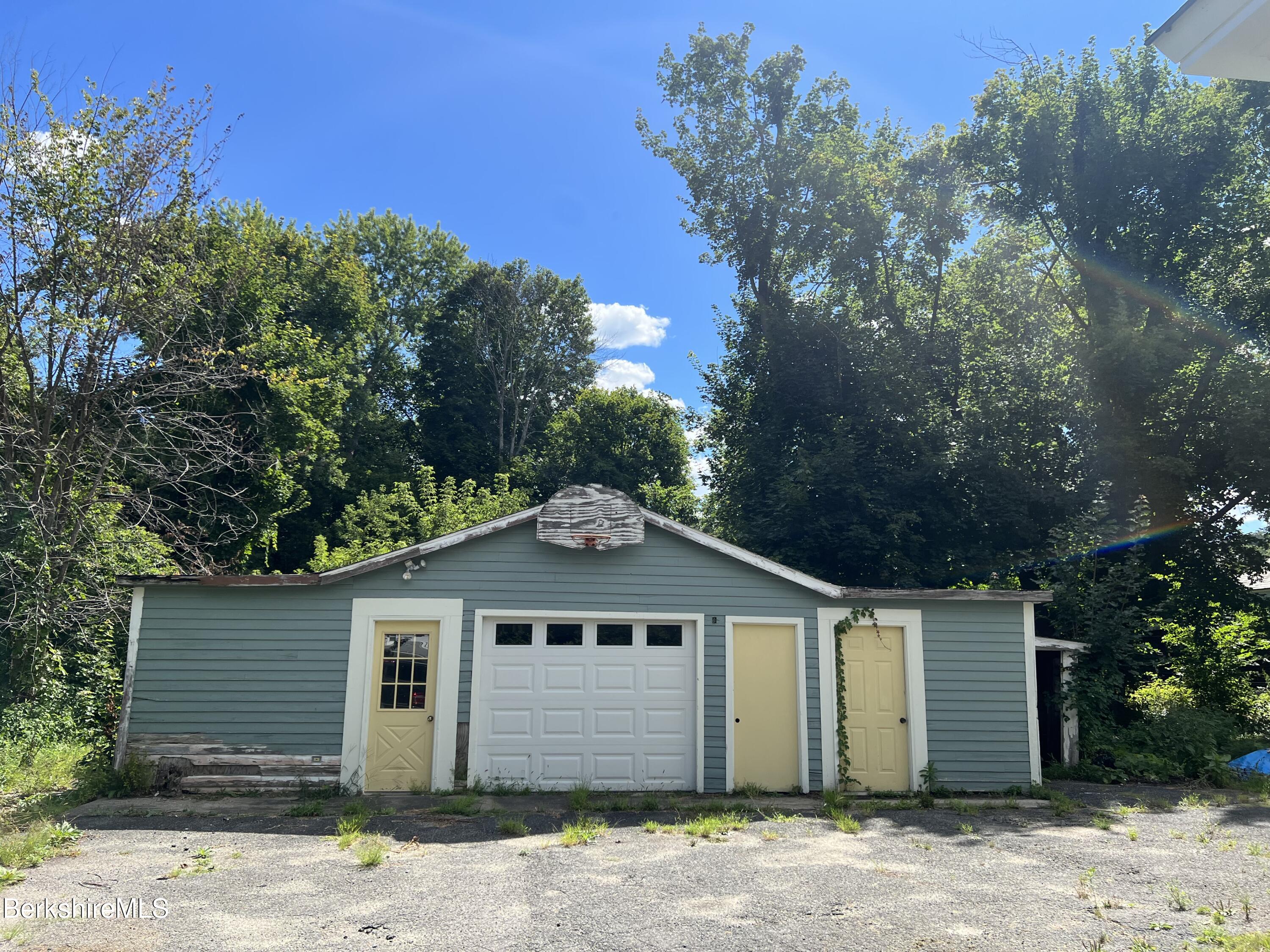 111 Columbia Street Adams, MA 01220 - Photo 3 of 21 a front view of a house with a yard and garage