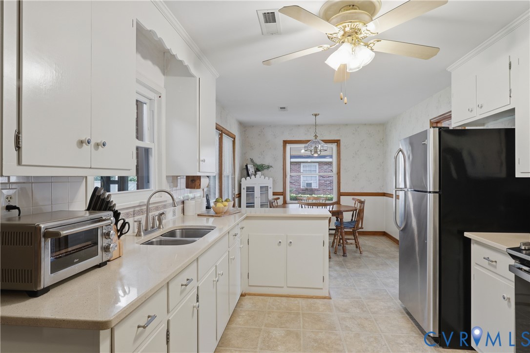 5210 Ronson Road North Chesterfield, VA 23234 - Photo 12 of 35 Kitchen featuring white cabinetry, light-toned cou
