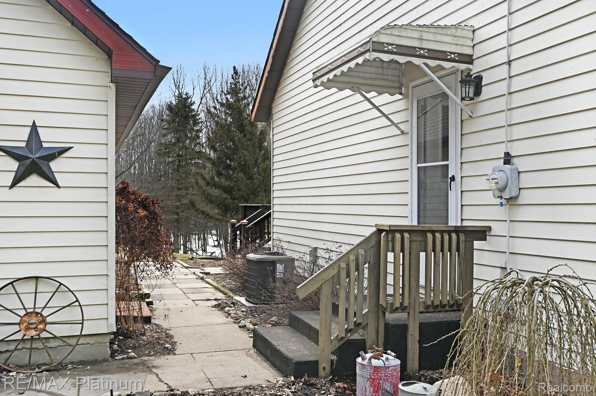 12451 Williams Road Byron, MI 48418 - Photo 2 of 29 Side door entrance