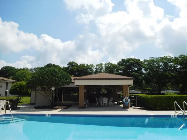 a garden with trees in front of a house