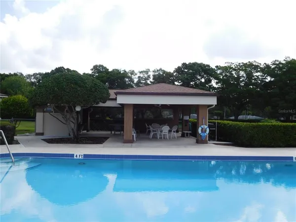 a view of a swimming pool with furniture