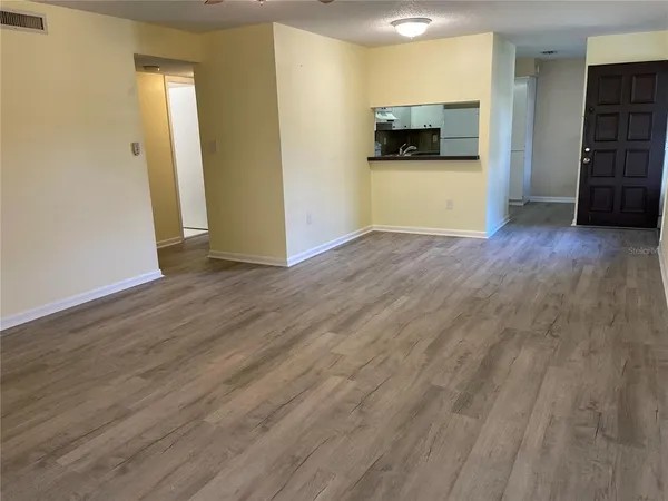 a view of a room with wooden floor and furniture