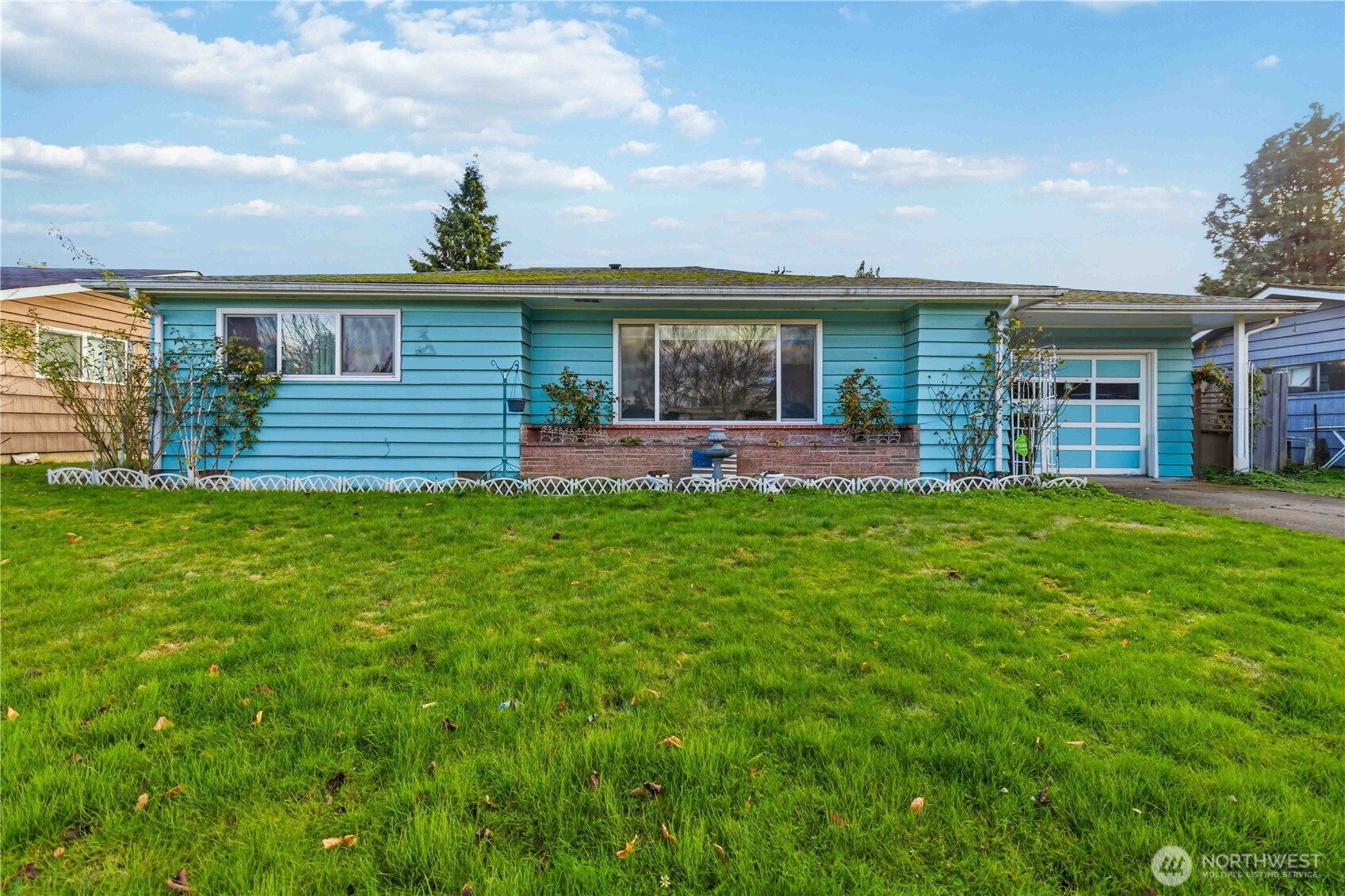 a front view of house with a garden and patio