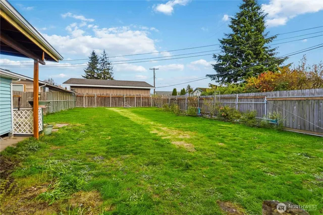a view of a house with a yard and sitting area