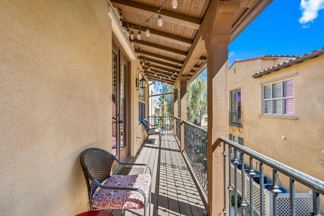 a view of a balcony with furniture