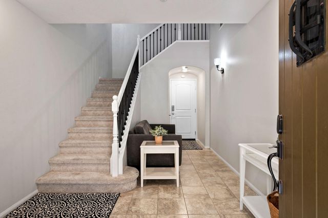 a view of entryway and hall with wooden floor