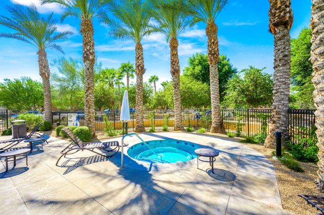 a view of swimming pool with outdoor seating and lounge chairs