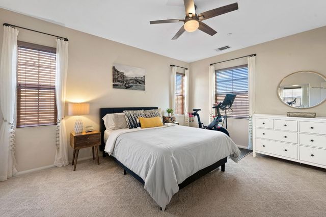 a bed room with a bed mirror and a window