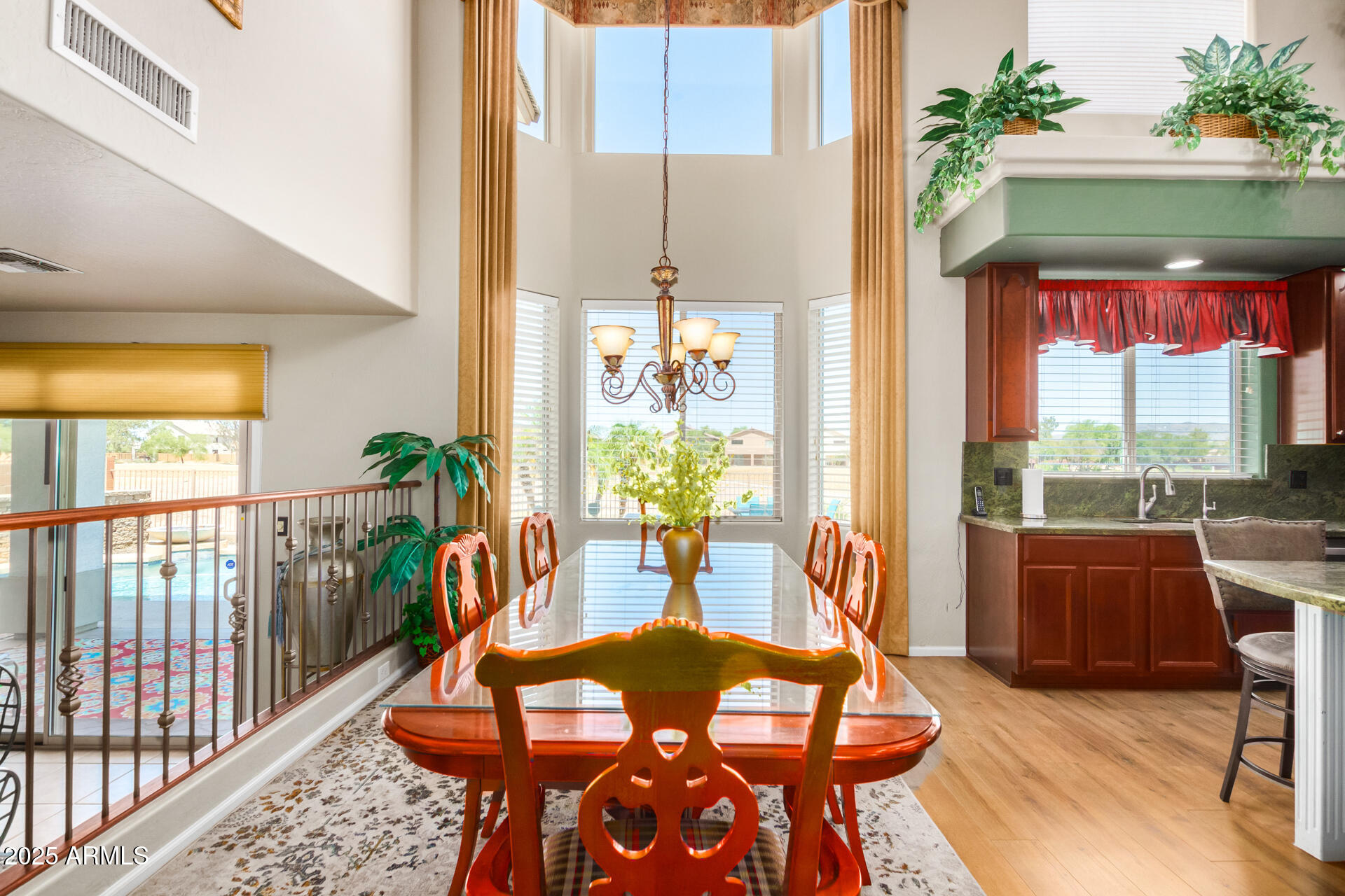 6635 South Cottonfields Lane Laveen, AZ 85339 - Photo 15 of 49 a dining room with furniture a chandelier and wooden floor