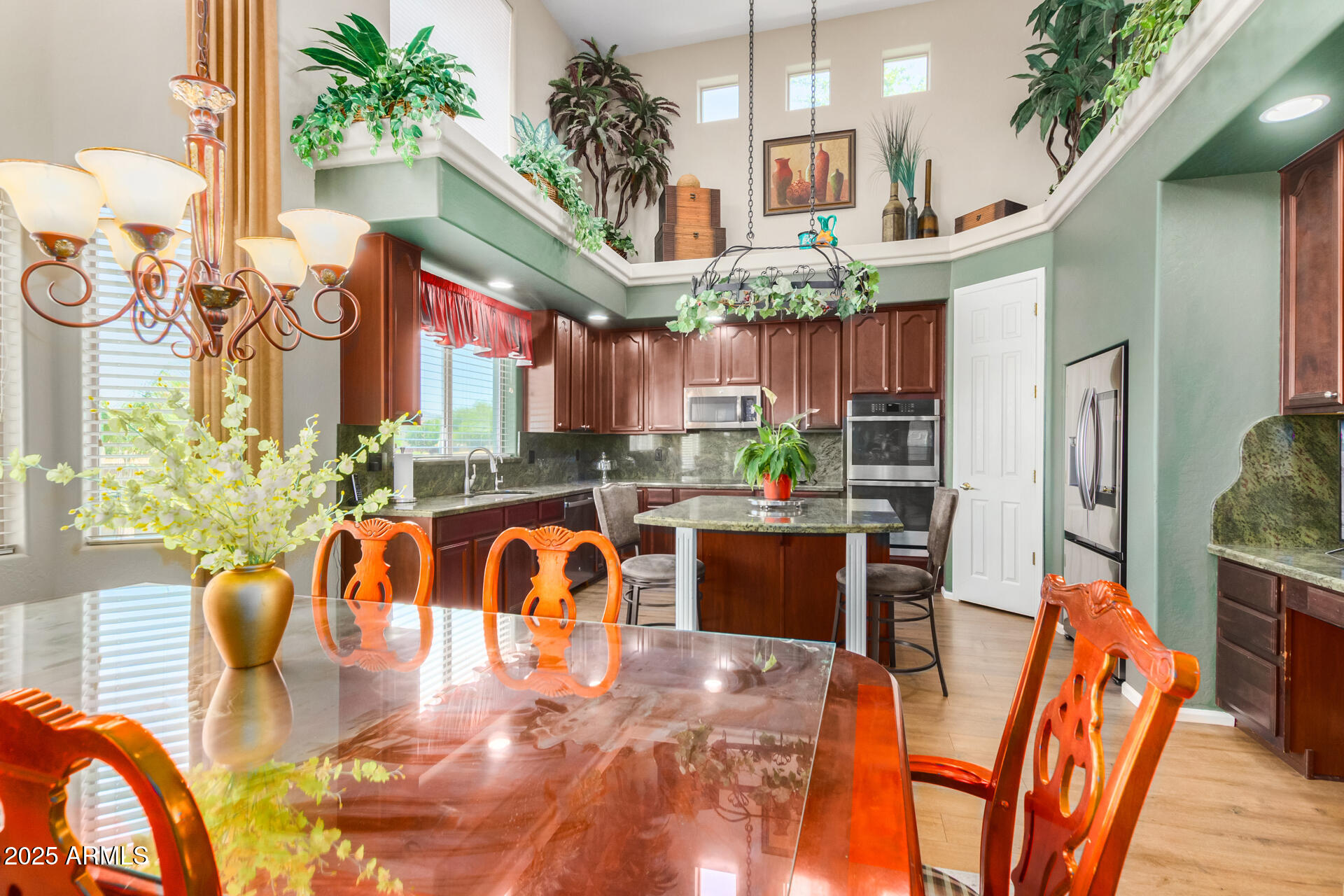 6635 South Cottonfields Lane Laveen, AZ 85339 - Photo 17 of 49 a living room filled with furniture hardwood floor and a kitchen counter