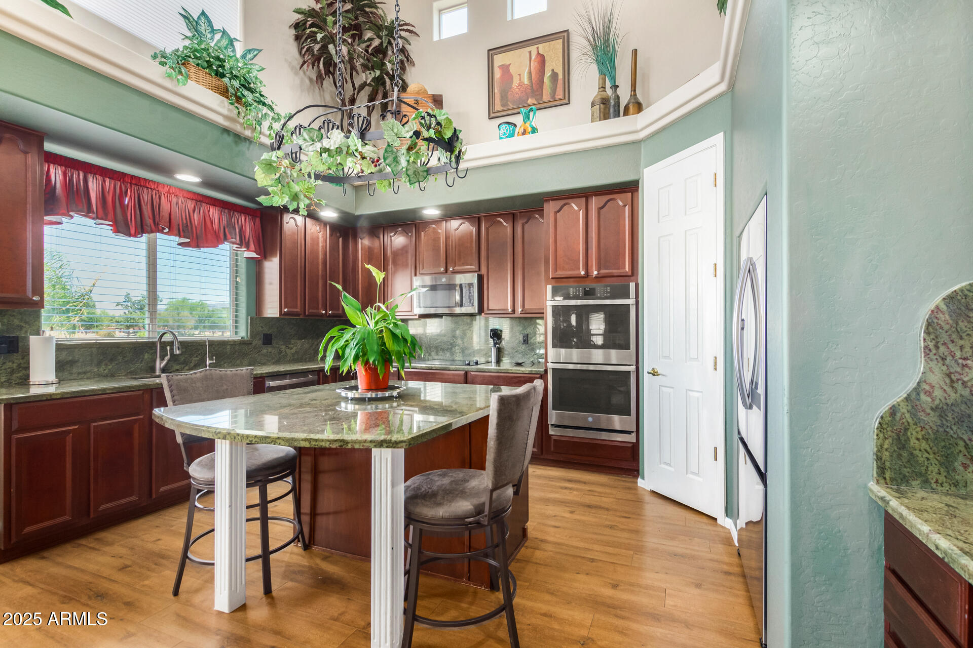 6635 South Cottonfields Lane Laveen, AZ 85339 - Photo 18 of 49 a dining room with furniture a large window and wooden floor
