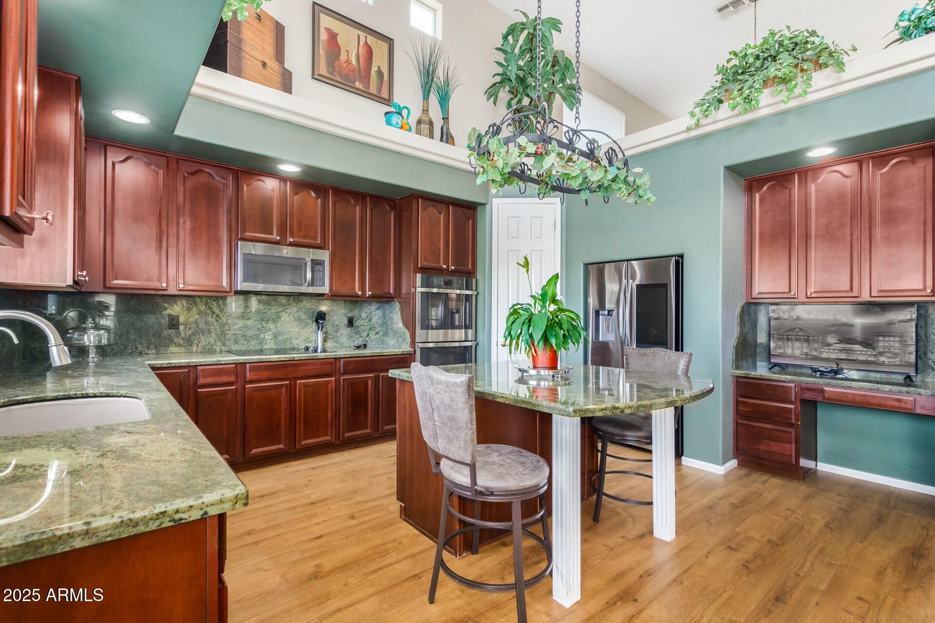 6635 South Cottonfields Lane Laveen, AZ 85339 - Photo 19 of 49 a kitchen with kitchen island a large counter top space appliances and cabinets