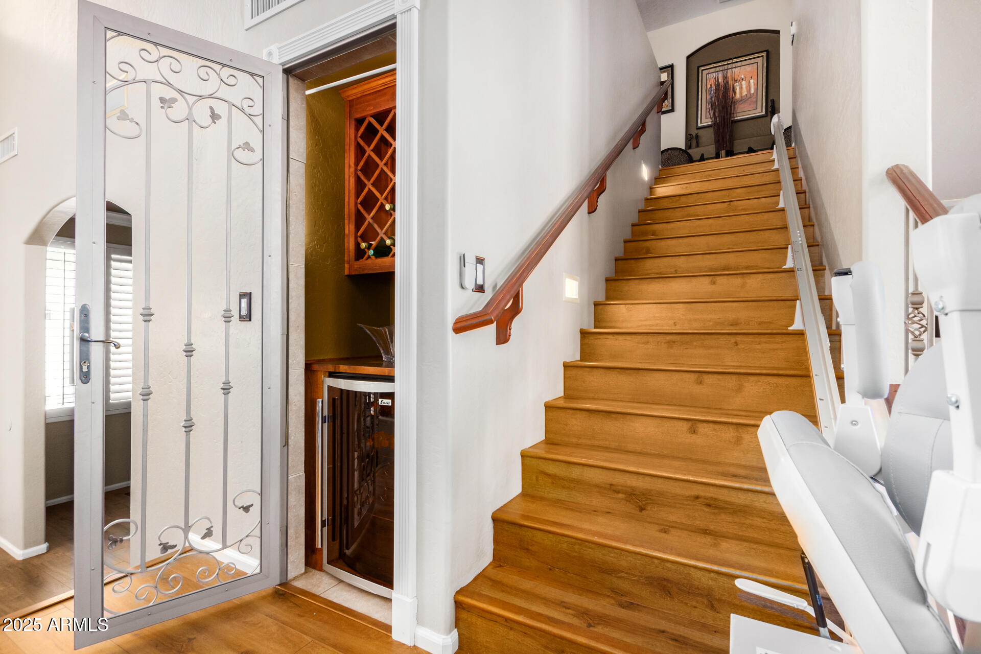 6635 South Cottonfields Lane Laveen, AZ 85339 - Photo 23 of 49 a view of staircase with lots of frames on wall and a window