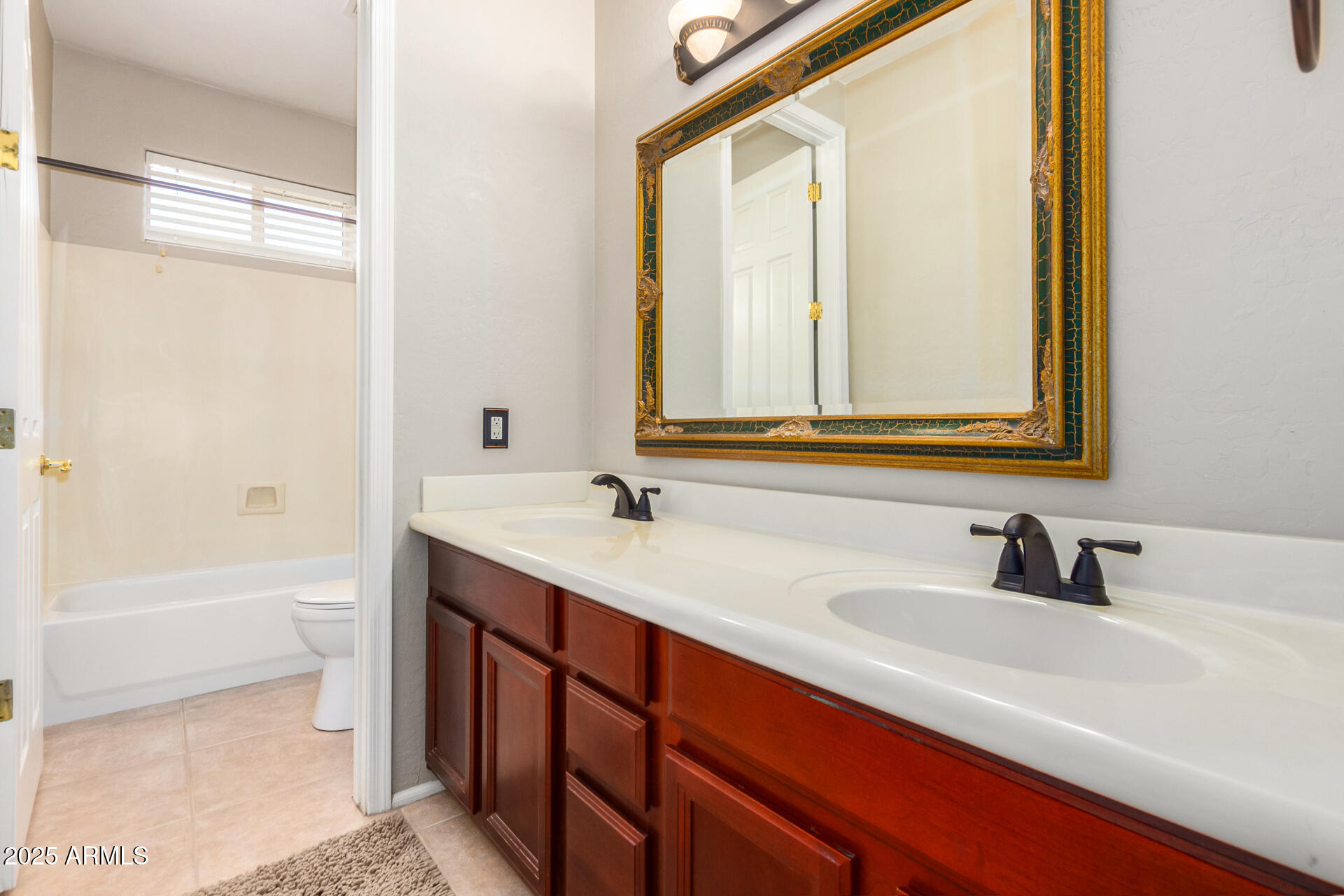 6635 South Cottonfields Lane Laveen, AZ 85339 - Photo 39 of 49 a bathroom with a double vanity sink mirror double and a bathtub