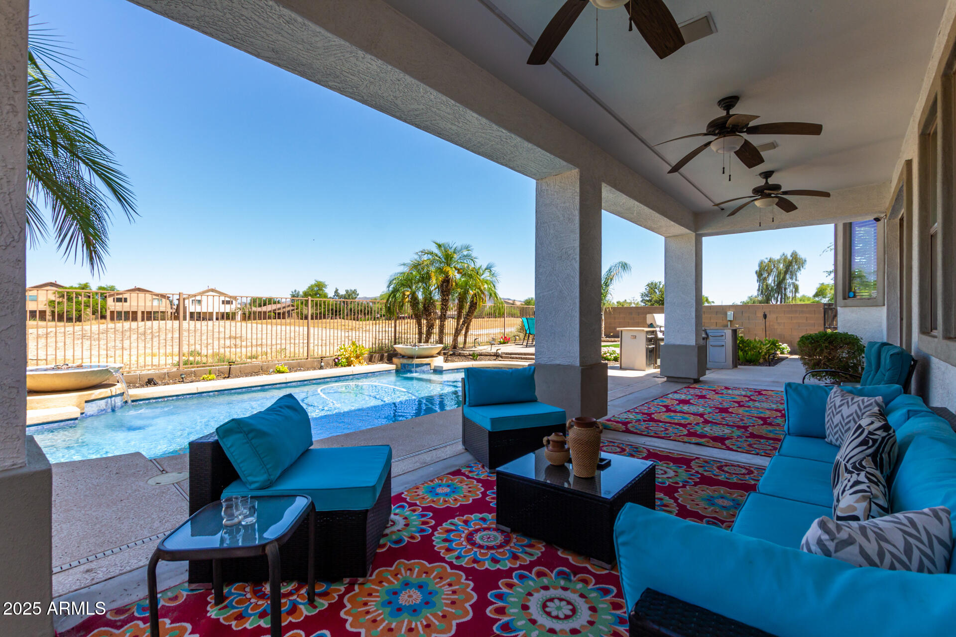 6635 South Cottonfields Lane Laveen, AZ 85339 - Photo 43 of 49 a outdoor space with patio the couches and pool chair with swimming pool view