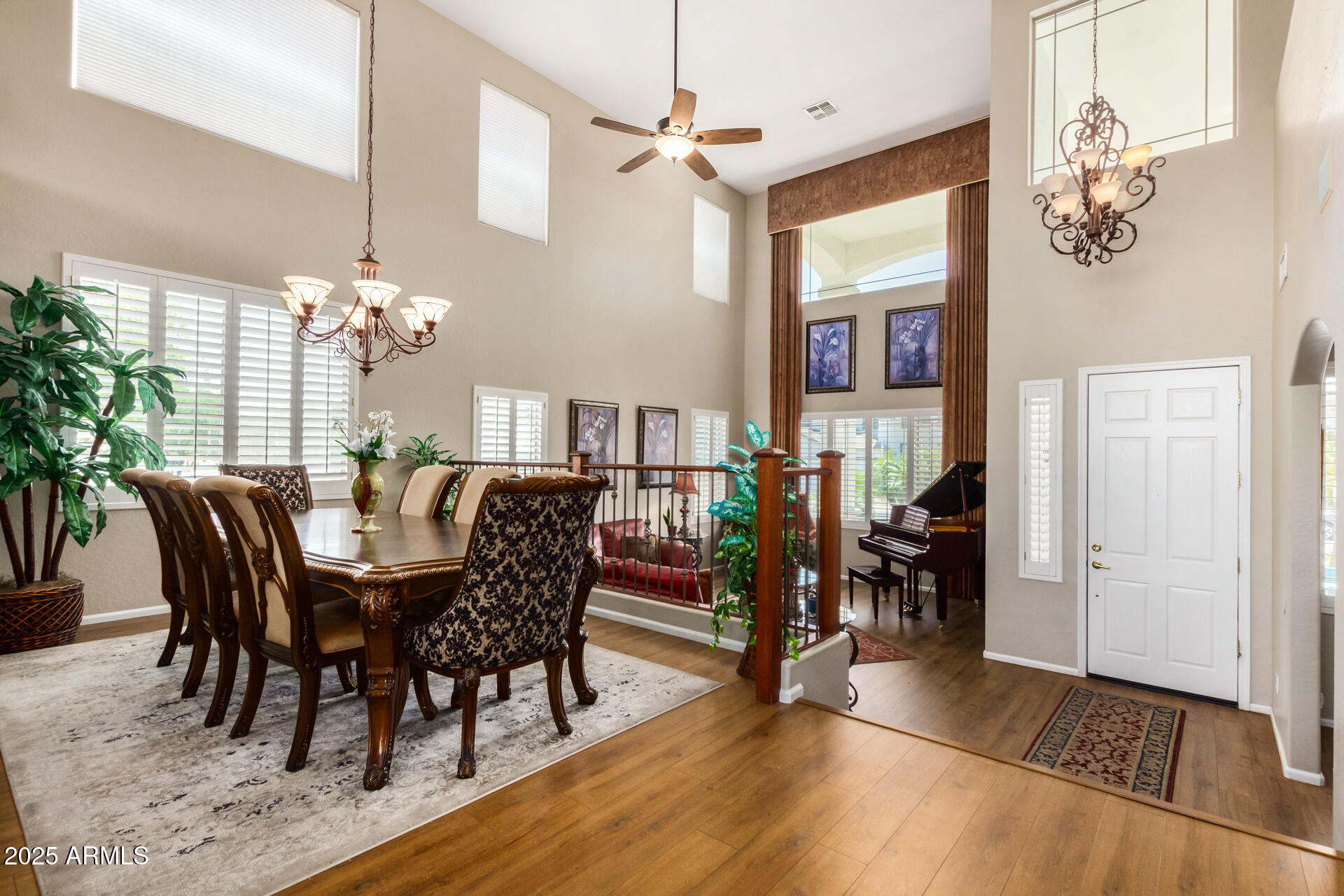 6635 South Cottonfields Lane Laveen, AZ 85339 - Photo 7 of 49 a dining room with furniture a chandelier and wooden floor