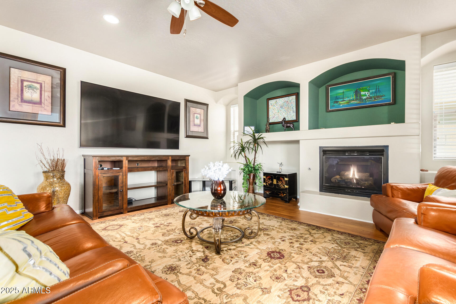 6635 South Cottonfields Lane Laveen, AZ 85339 - Photo 10 of 49 a living room with furniture a flat screen tv and a fireplace