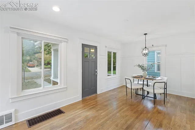 a kitchen with a sink and wooden floor