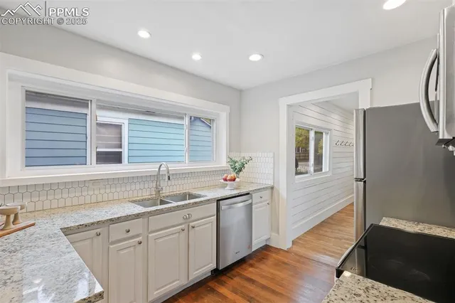 a kitchen with stainless steel appliances a stove microwave and refrigerator