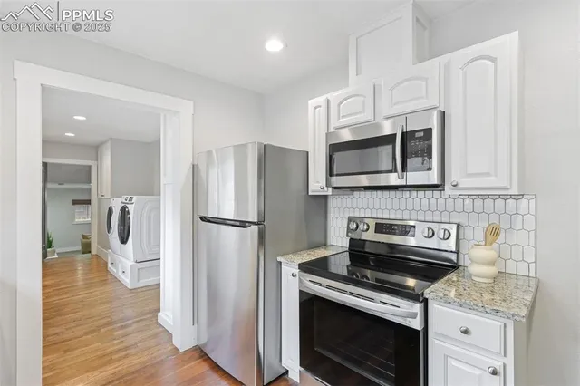 a view of a hallway with washer and dryer