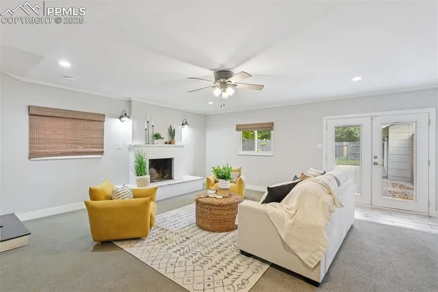 a living room with furniture and a ceiling fan