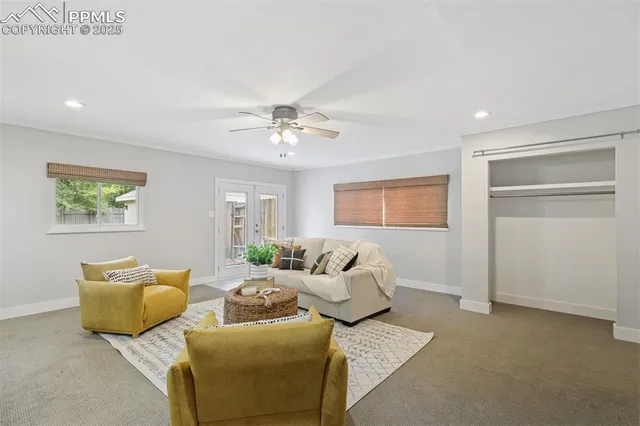 a living room with furniture a chandelier and a window