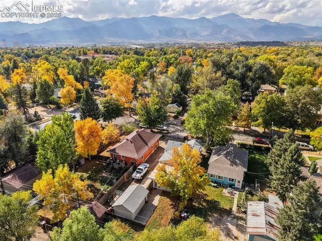 an aerial view of residential house with swimming pool and green space