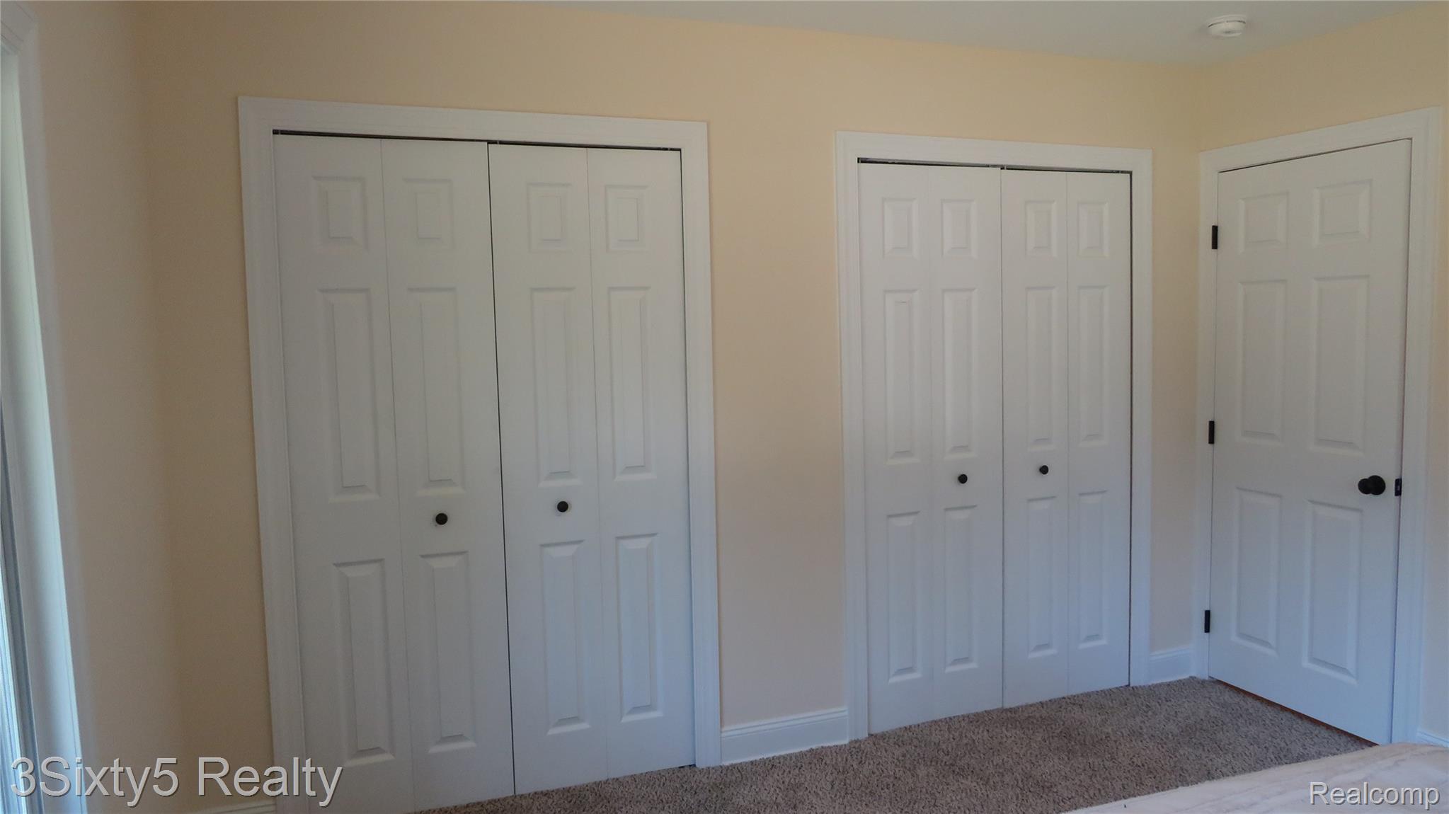 16558 Haggerty Road Belleville, MI 48111 - Photo 25 of 40 Beige-painted walls complementing white trim work and paneled doors