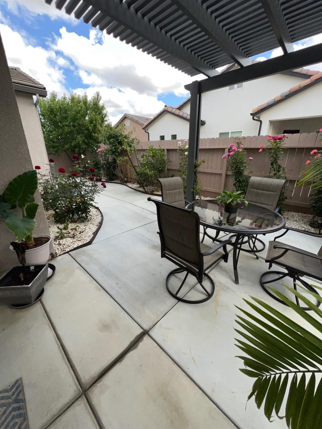 889 Coloma Place Madera, CA 93637 - Photo 47 of 61 a view of a patio with chairs and potted plants