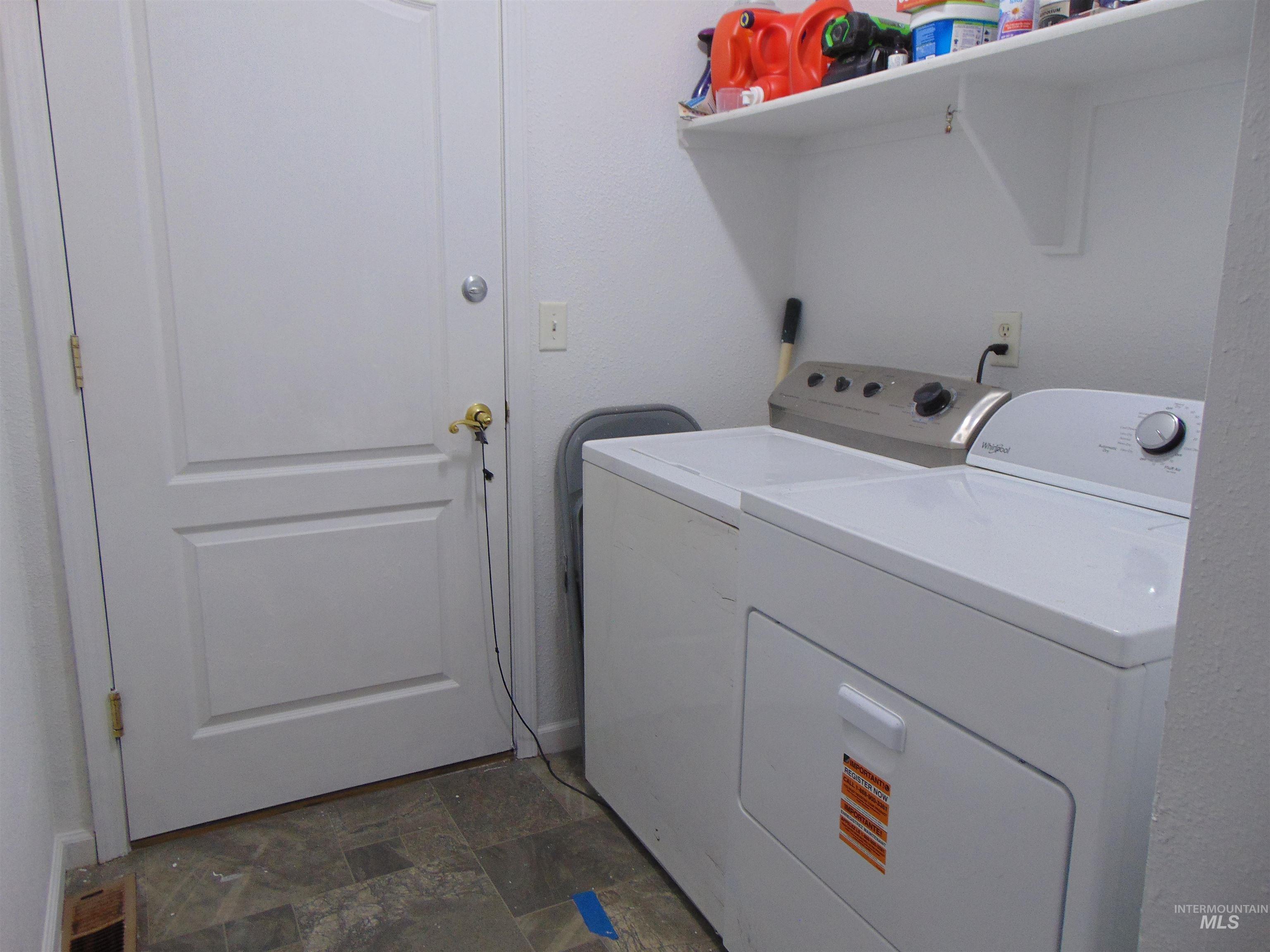 30 Maple Drive Weiser, ID 83672 - Photo 12 of 17 Laundry room featuring stone finish flooring and washer and dryer