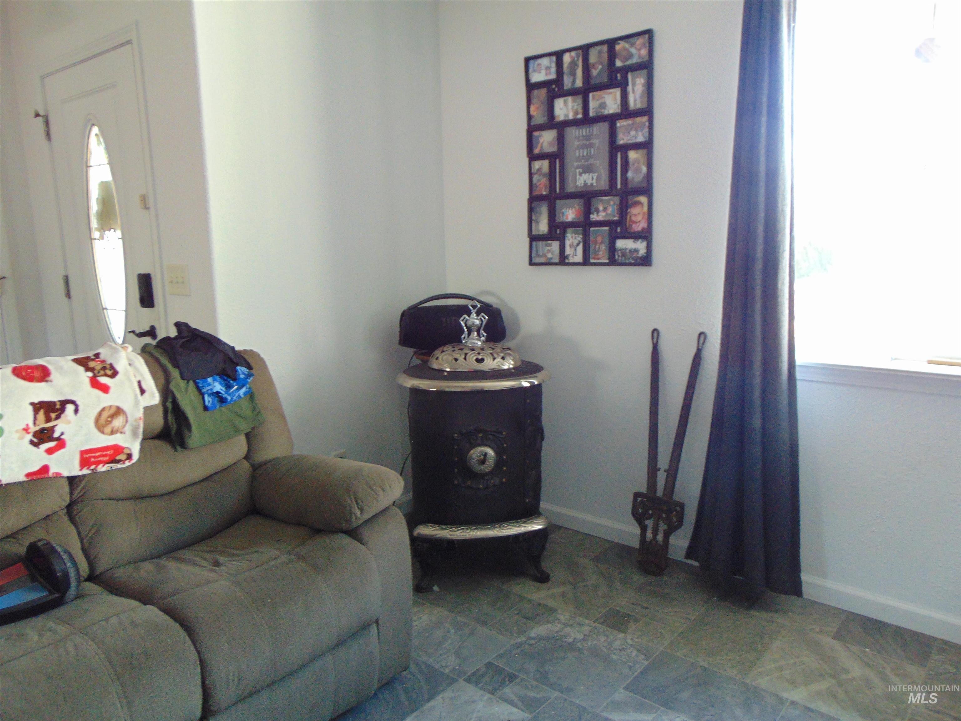 30 Maple Drive Weiser, ID 83672 - Photo 3 of 17 Sitting room featuring stone finish flooring and healthy amount of natural light