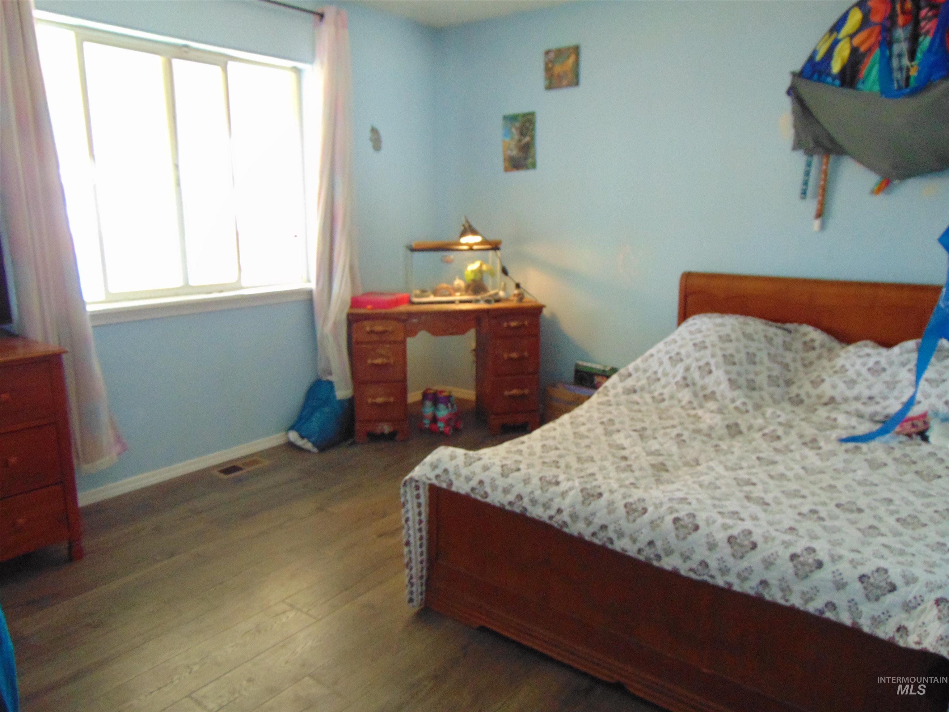 30 Maple Drive Weiser, ID 83672 - Photo 8 of 17 Bedroom with dark wood-type flooring and baseboards