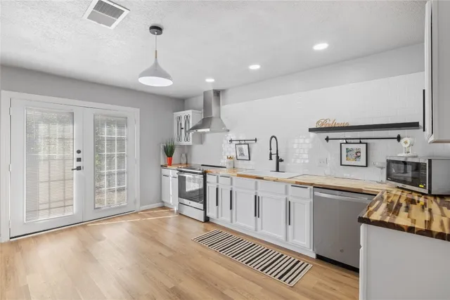 a kitchen with stainless steel appliances granite countertop a sink and cabinets